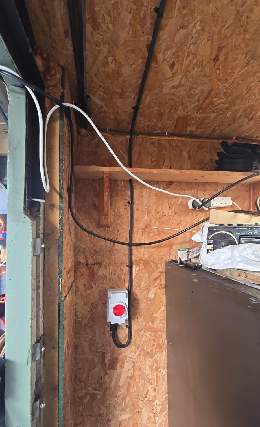 Steel Wire Armoured (SWA) cable clipped to exterior wall