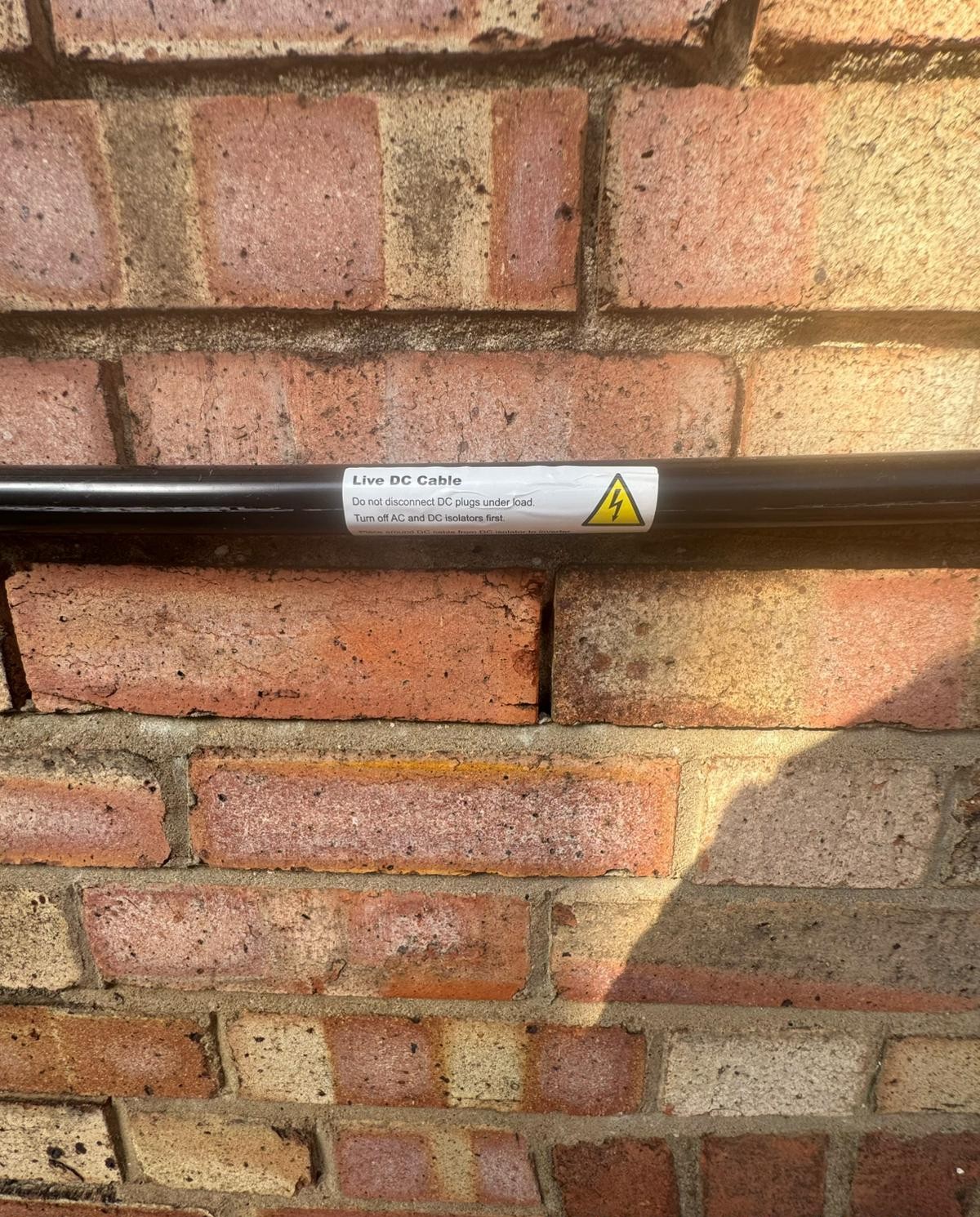 Solar DC string conduit and warning label